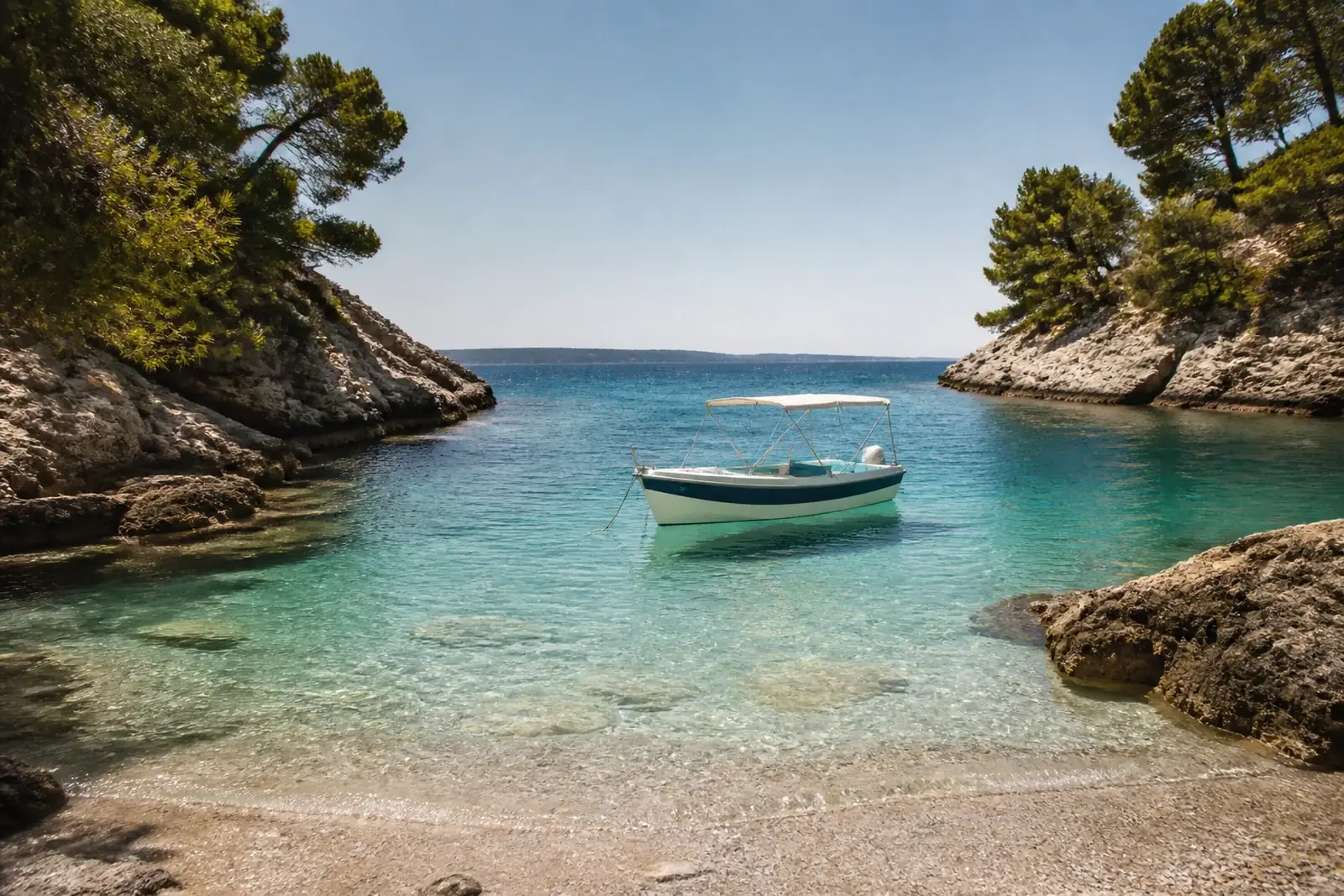 Hidden cove with a boat anchored a few metres from the shore