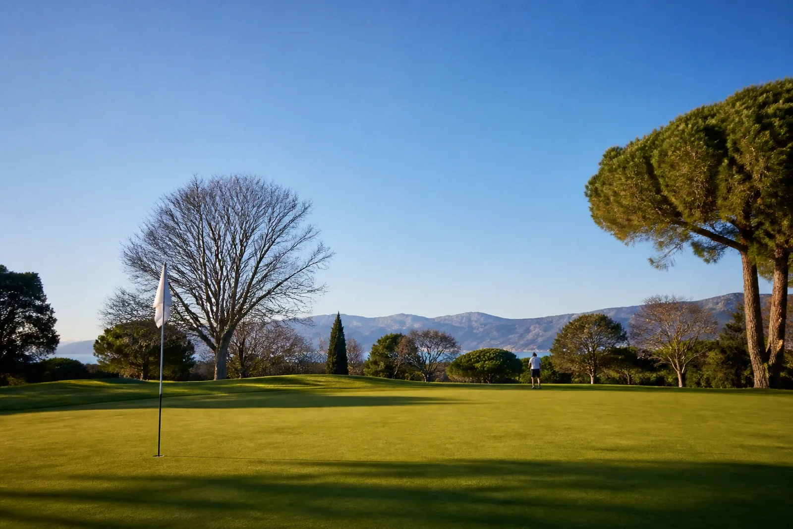 Golf course in Girona in midwinter with green turf and a clear sky